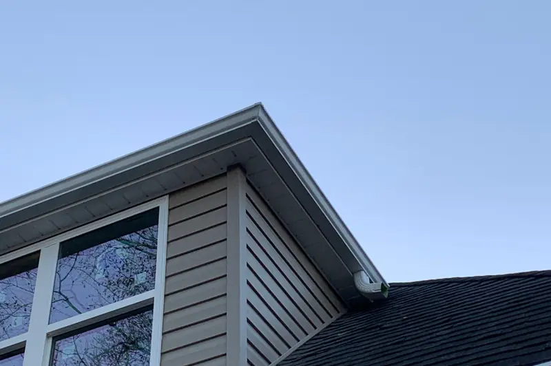 Sided dormer on a dark shingle roof with a white gutter below, a Mosqueda Construction job