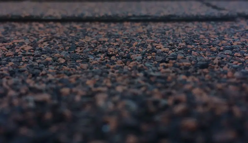 Close view of asphalt shingle granules on a roof