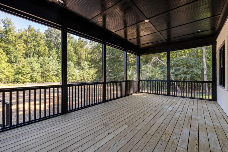 Screened porch with new wood decking facing trees