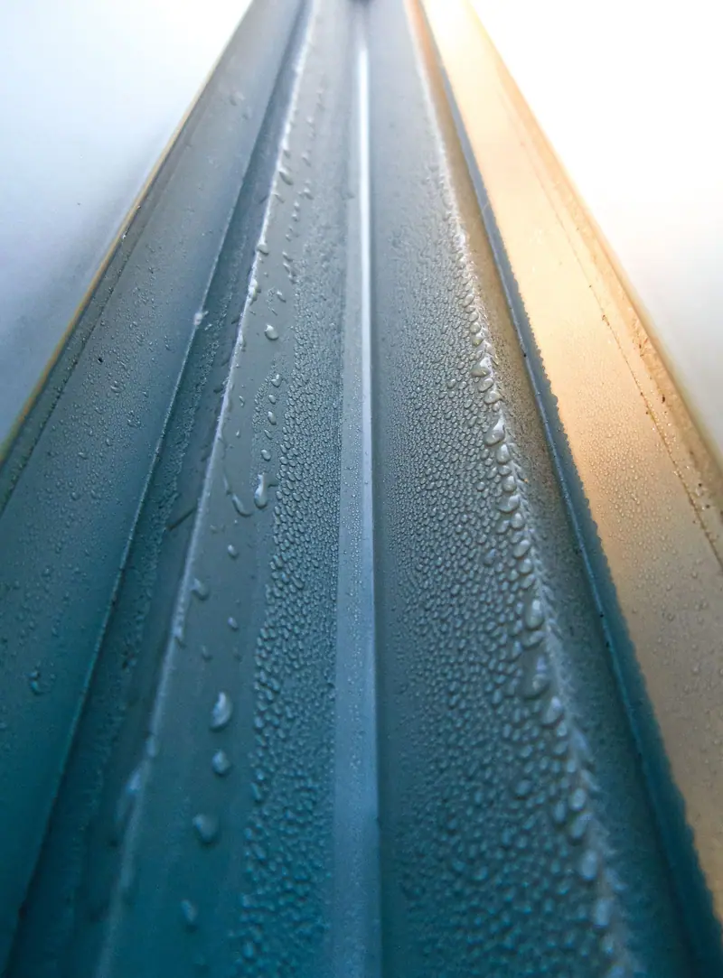 Rain beading on a standing seam metal roof panel