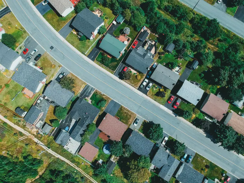 Aerial view of a residential street lined with shingle-roofed houses